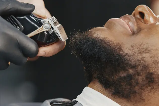Close-up of a beard being shaped with clean edges