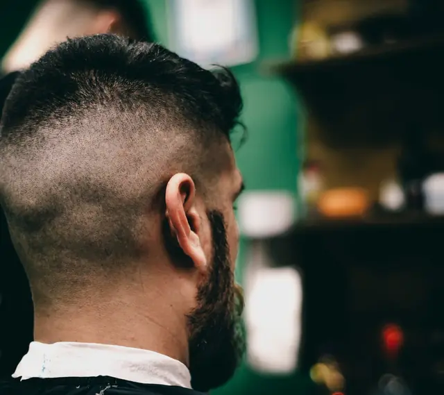 Back view of a finished short haircut and beard